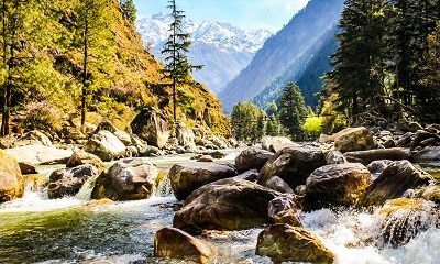 Scenic river flowing through mountain valley with rocks and trees