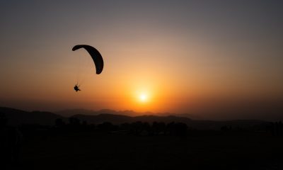 Young Man Paragliding during sunset - Camping and Paragliding in Bir Billing