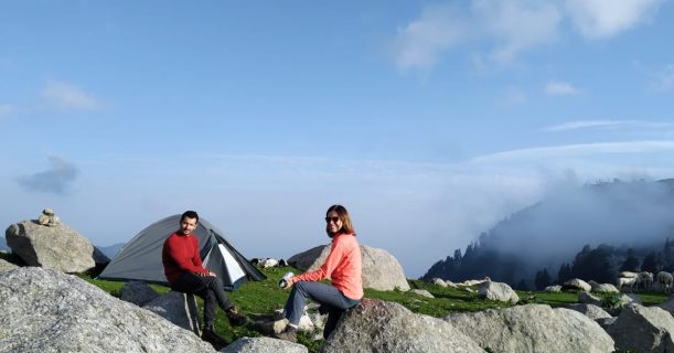 Two Friends Enjoying View from Top of a Hill at Indrahar Pass Trek
