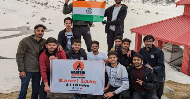 A bunch of friends pose with an Indian flag, showcasing their shared pride and celebration of their heritage.