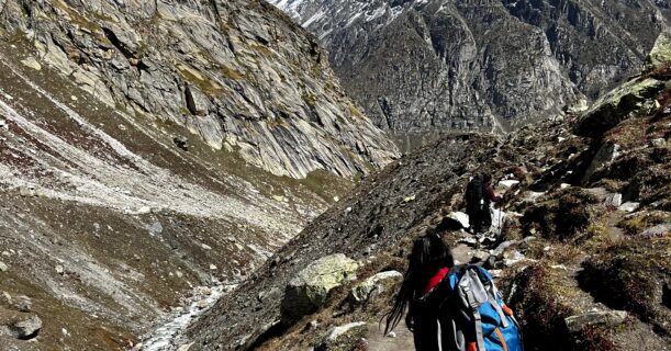 Trekker hiking on the Hampta Pass Trek trail with Himalayan mountains