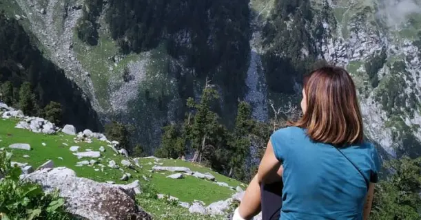 A Girl Sitting and Watching the Beautiful View of Indrahar Pass Trek