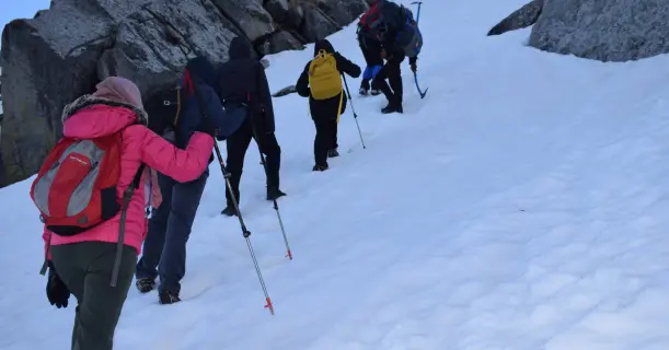 Some friends trekking up a snow-covered mountain.