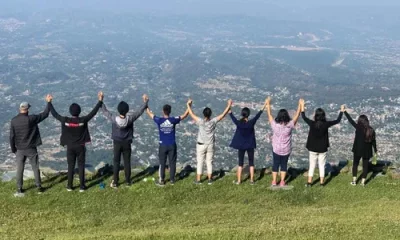 Team of Trekkers Men and Women holding hands