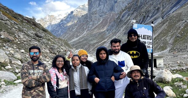 Group of trekkers posing in the Himalayan valley on Hampta Pass Trek