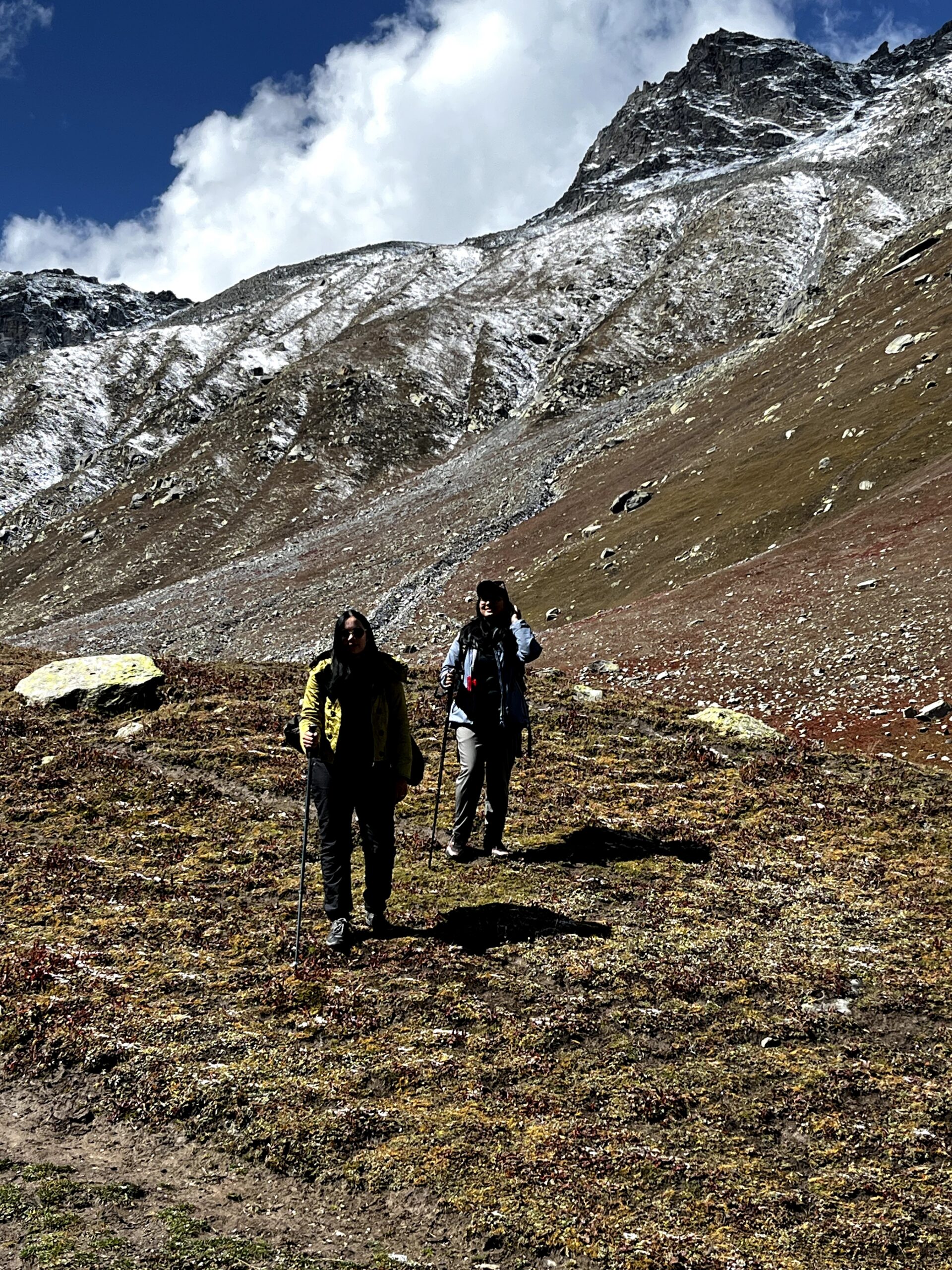 Trekkers hiking through a rocky Himalayan mountain trail