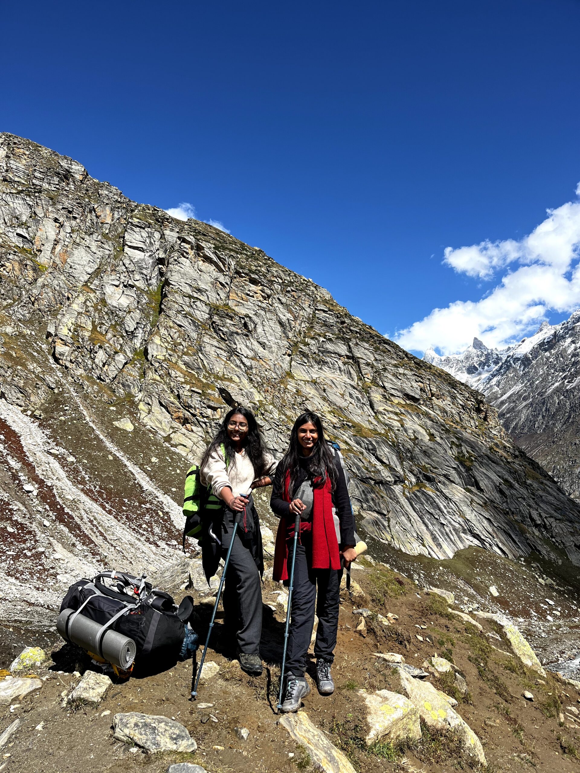 Trekking group crossing a Himalayan river near mountain campsites