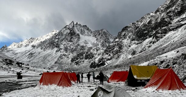Snow-covered mountain campsite with trekking tents in the Himalayas