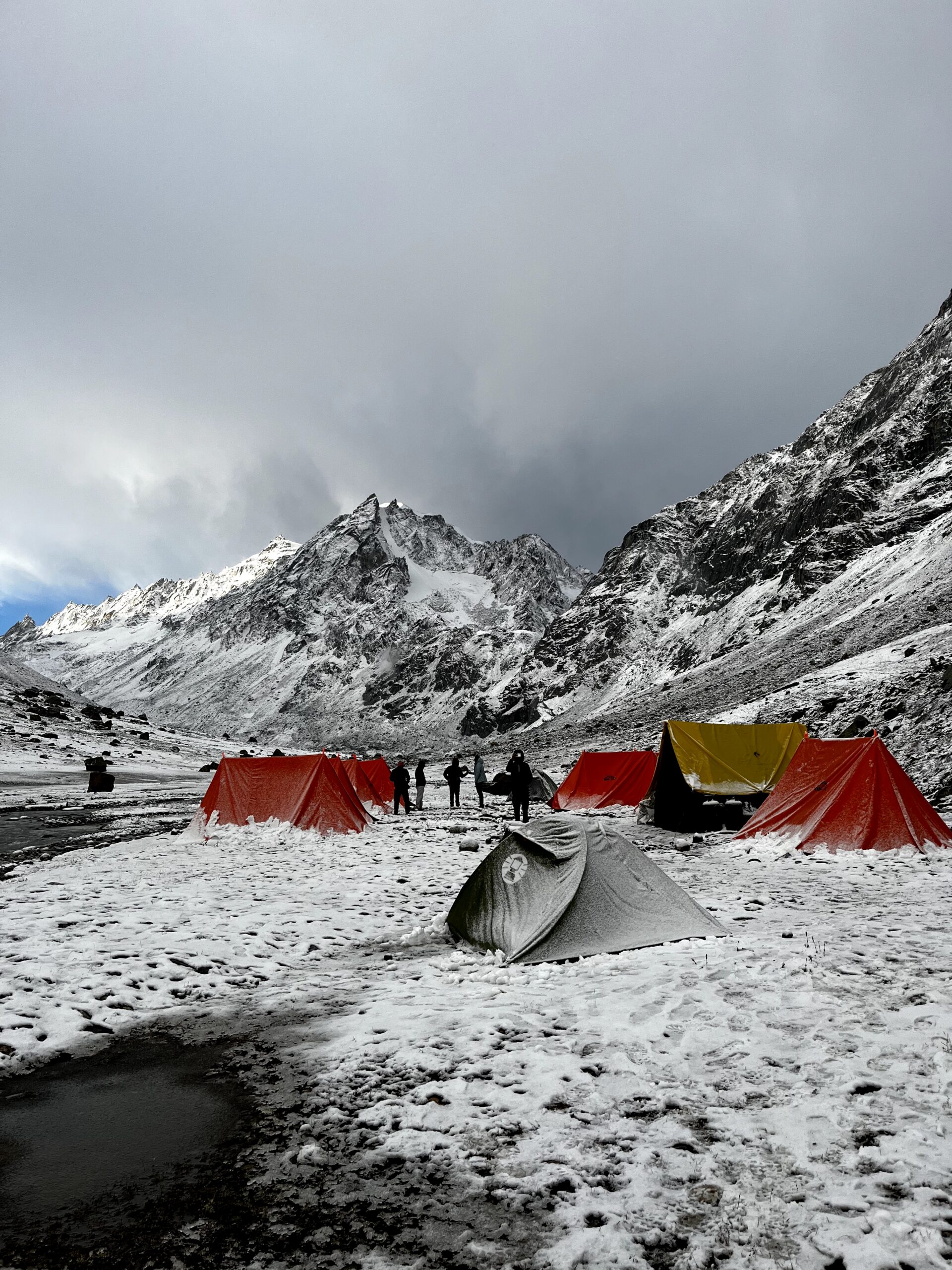 Snow-covered mountain campsite with trekking tents in the Himalayas