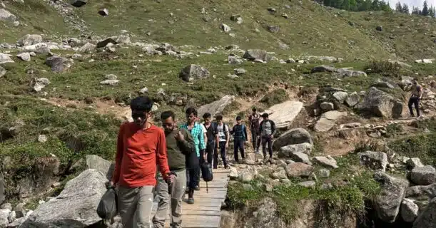 A group of people is walking on the bridge - Hampta Pass Trek