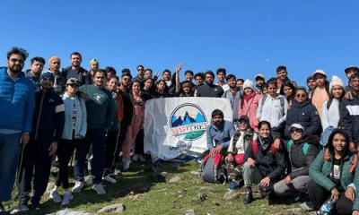 Trekkers Holding Banner with the Logo of MadTrek Adventures