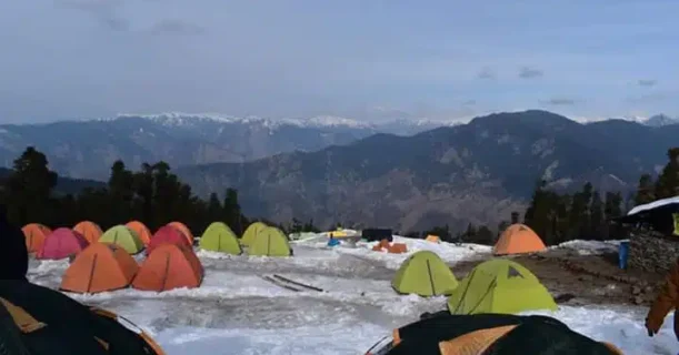 A collection of tents stands on a snow-blanketed ground, highlighting the contrast between the colorful tents and the white snow.