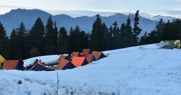 Tents are arranged on a snowy hill, providing shelter in a cold, snowy environment.