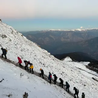 Hikers climbing a snowy mountain in winter gear