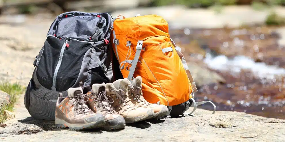 Hiking boots and backpack on rock