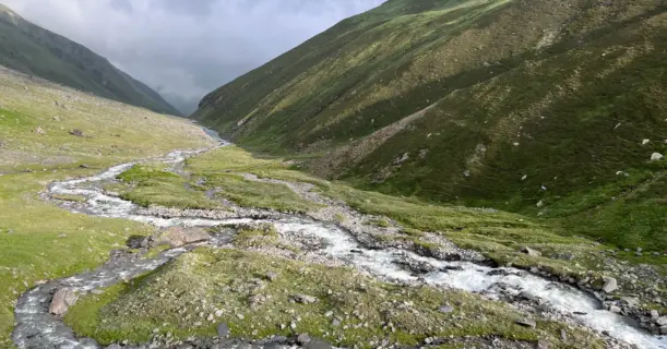 Serene valley with a glacial stream on the Pin Bhaba Pass trek between Mulling and Kara