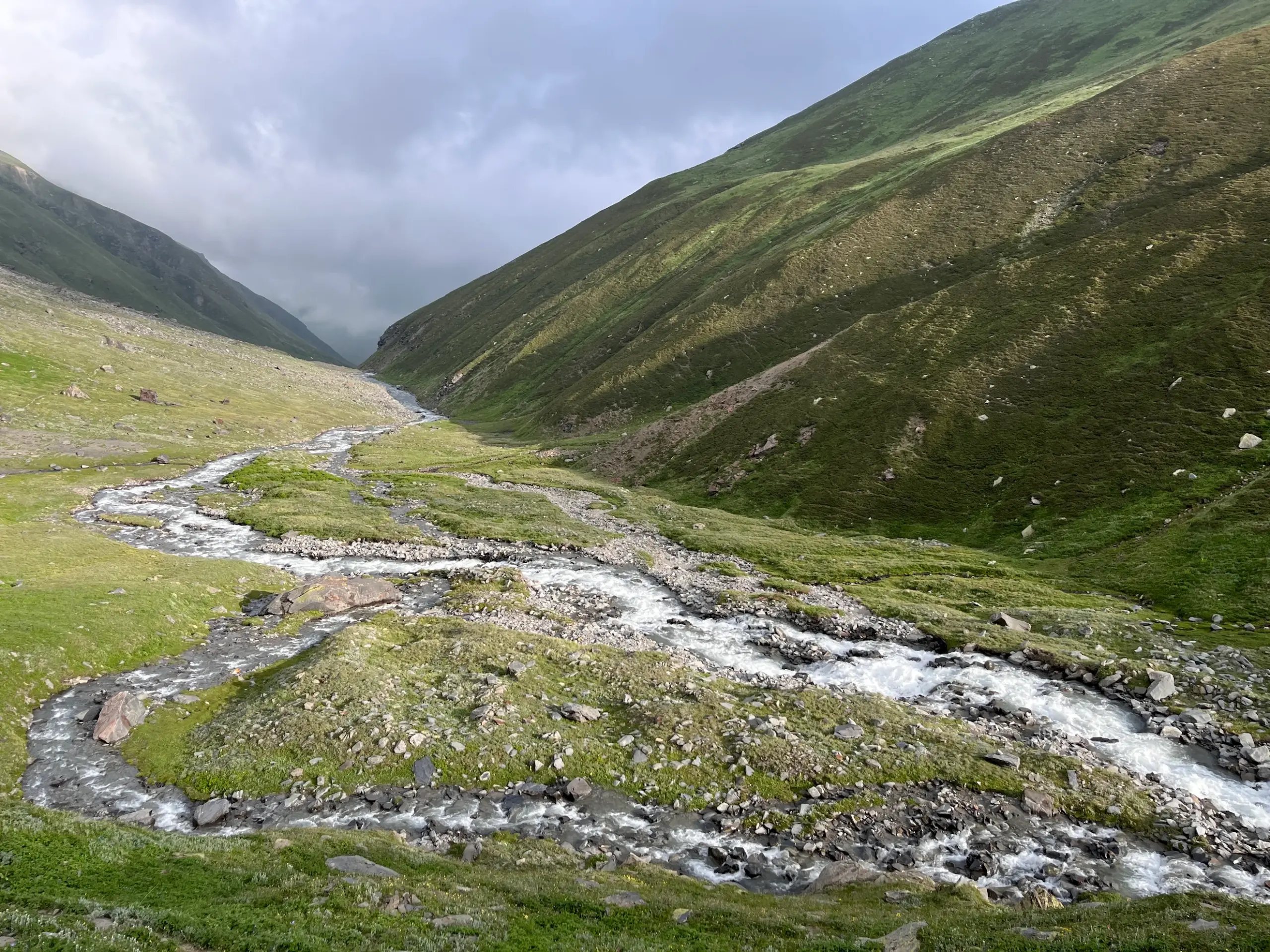 Serene valley with a glacial stream on the Pin Bhaba Pass trek between Mulling and Kara