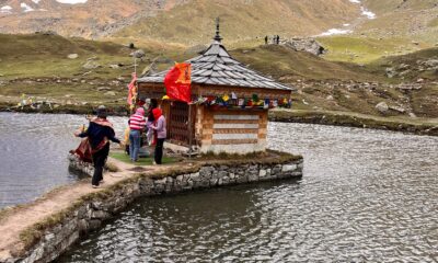 Krishna temple on the banks of Yulla Kanda Lake surrounded by snow-capped Himalayan mountains in Himachal Pradesh