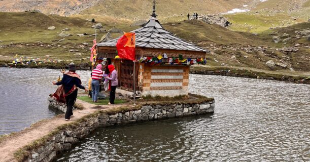 Krishna temple on the banks of Yulla Kanda Lake surrounded by snow-capped Himalayan mountains in Himachal Pradesh