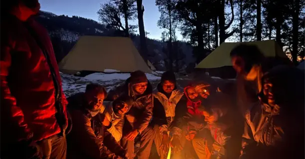 Group around campfire at night