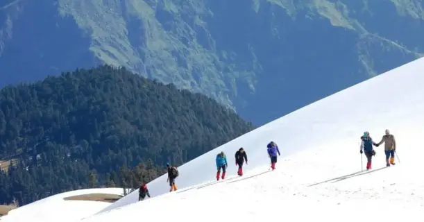 Group of hikers climbing a snowy mountain
