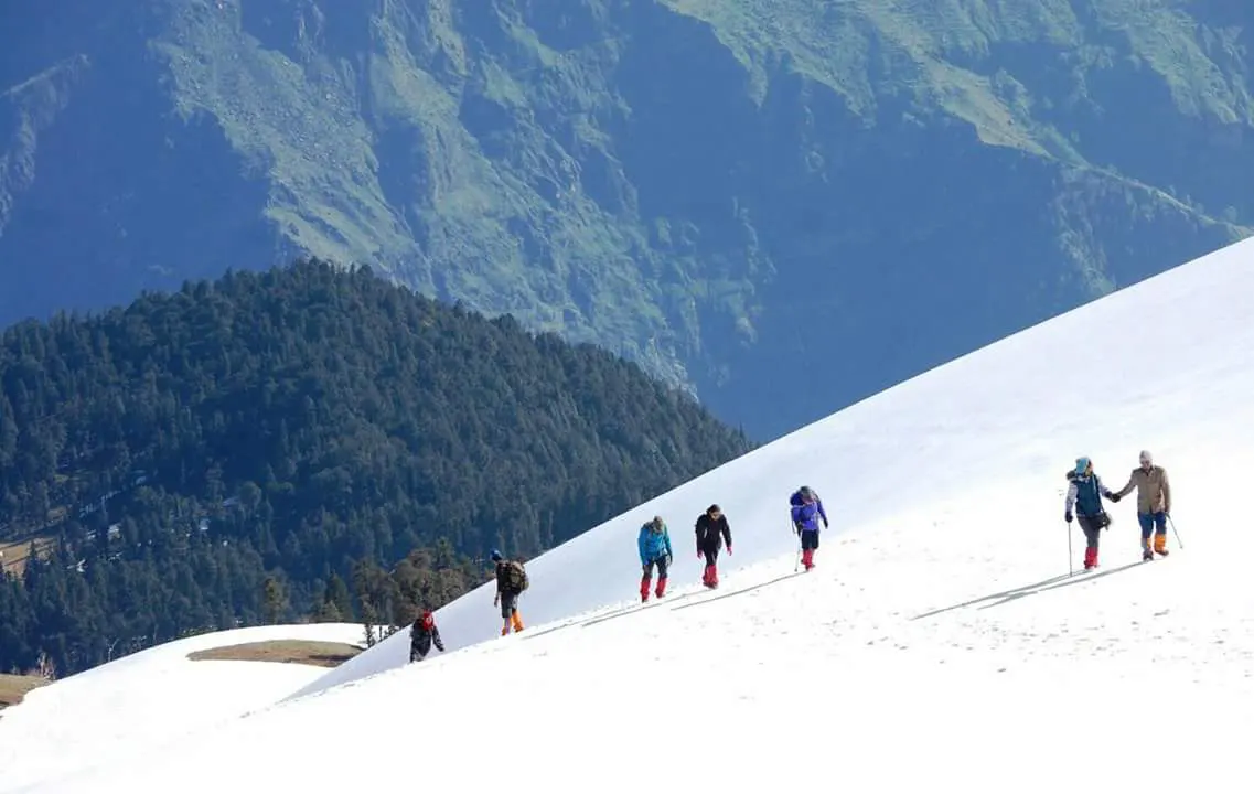 Group of hikers climbing a snowy mountain