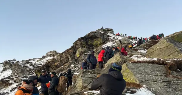 People enjoying a snowy mountain landscape in winter gear