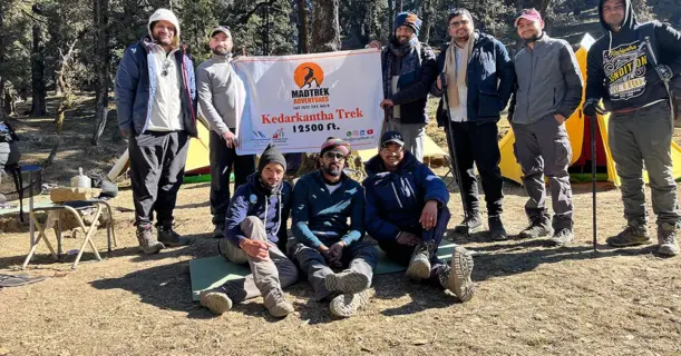 Group of people smiling near colorful tents
