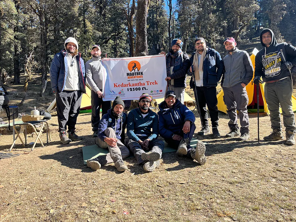 Group of people smiling near colorful tents
